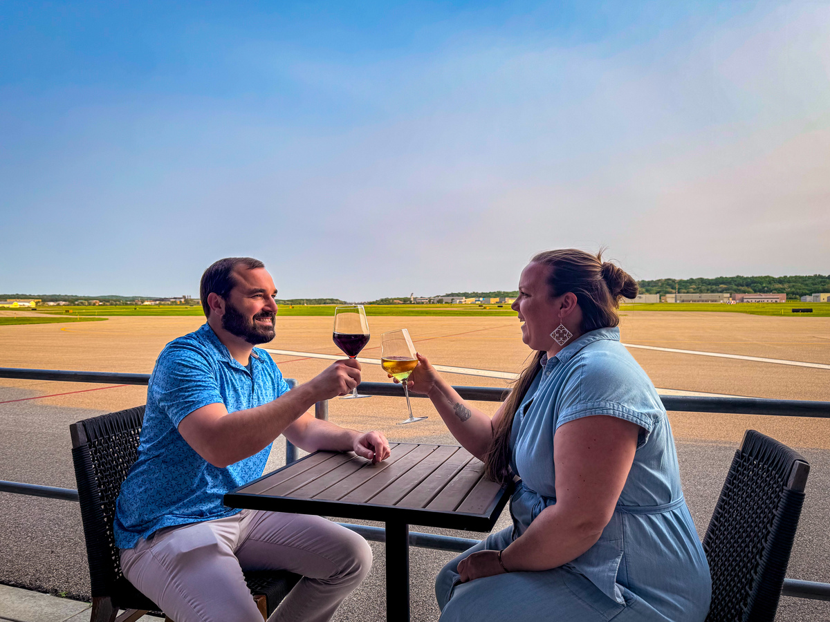Antonia and her husband cheers while dining at Holman's Table.