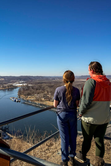Antonia and her daughter look at the Mississippi River from atop Barn Bluff.