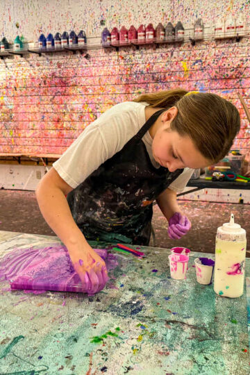 A young girl paints at Mess Hall Arts, one of the best things to do in Hopkins with kids.