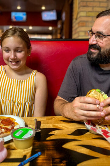 A man and his young daughter eat lunch at Johnny B’s Brickhouse.